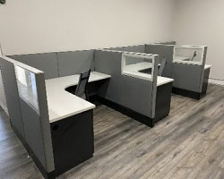 Modern Haworth Premise glass panel office workstation with power down spine.