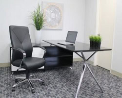 Luxurious black leather executive chair with chrome accents in modern office setting.