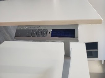 HAT & Work Rite digital control panel on a modern desk setup.