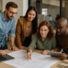 Diverse team collaborating on furniture design plans in a modern office.