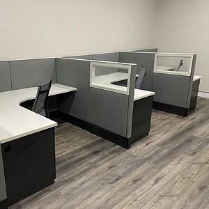 Modern Haworth Premise cubicles with glass panels for office privacy.