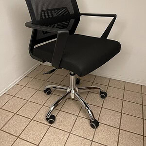 Ergonomic mesh back task chair with adjustable height and armrests, ideal for office and home worksp.