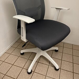 Office task chair with white frame and charcoal fabric seat.