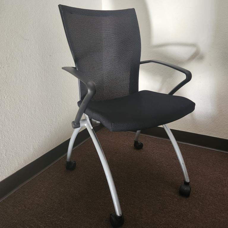 Haworth X99 black mesh nesting chair with casters, ideal for modern office environments. Ergonomic d.