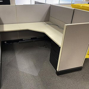 Modern Herman Miller Momentum A02 cubicle with beige fabric panels and white desk.