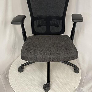 Ergonomic Haworth Zody office chair with black mesh and charcoal seat.
