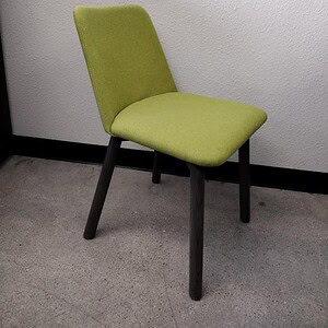Lime green upholstered wood chair with black legs, modern mid-century design.