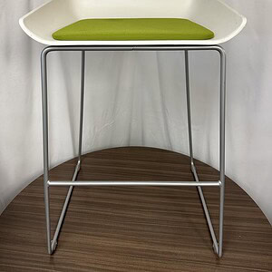 White Steelcase Scoop Stool with green cushion, modern office seating.