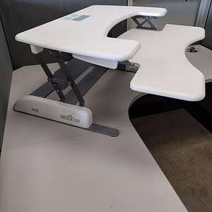 Modern white sit-stand desk for ergonomic workspace flexibility.