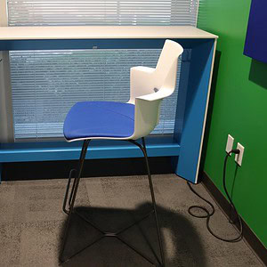Modern 5'x18' Steelcase powered USB table with ergonomic chair in office setting.