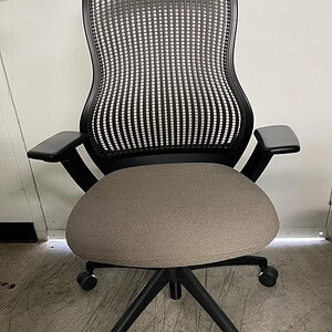 Office chair with neutral color mesh back and cushioned seat, ergonomic design for comfort and suppo.