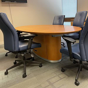 Honey Walnut oval conference table for professional meeting rooms.