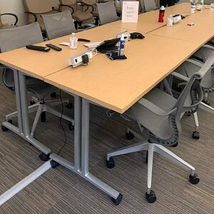 Mobile training tables on caster wheels for easy mobility and versatile conference room setups.