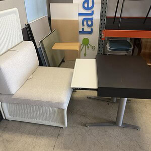 Black lounge height table with beige seating and adjustable chairs at Cube World USA.