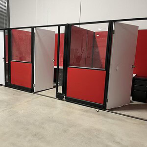 Red and white Herman Miller AO2 privacy cubicles, 85 inches tall, ideal for modern office spaces.