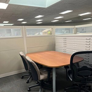 Mobile cherry conference table with casters for flexible office use.