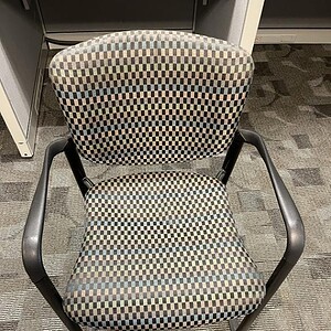 Haworth Improv patterned guest chair with checkered fabric and black metal arms, ideal for office or.