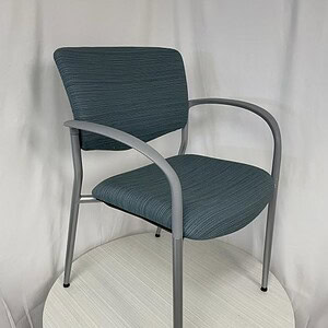 Blue Trendway guest chair with stacking feature, modern design, and metal armrests.