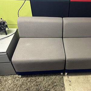 Grey modular sofa for lounge areas, ideal for modern office spaces and collaborative environments.