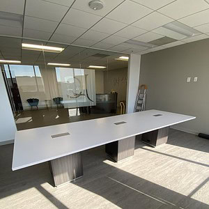 Conference table with grey and white finish, ideal for professional office settings and meetings.
