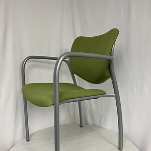 Lime green Haworth stacking side chair with metal frame, ideal for modern office or conference room.
