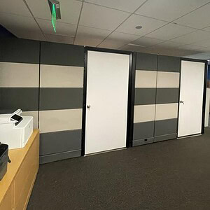 Herman Miller cube with white doors in modern office space, ideal for workspace organization and pri.