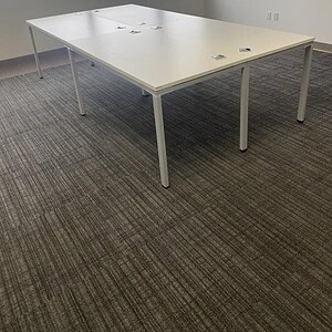 Modern office desk with clean design, perfect for collaborative workspaces. No peds included, easy t.