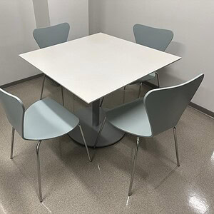 White 3'x3' Teknion breakroom café table with four matching chairs.