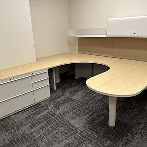 Modern private office desk with neutral tones and ergonomic design.