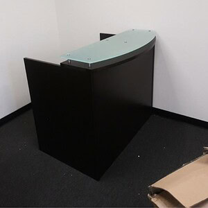 Modern reception desk with glass top for contemporary office spaces.