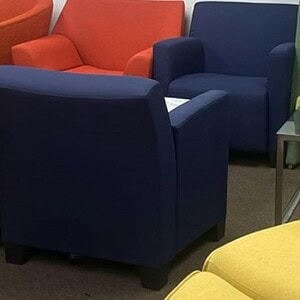 Royal blue lounge chair from Steelcase Turnstone collection in modern office setting.