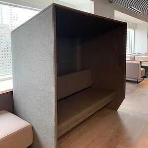 Modern Haworth BuzziSpace Canopy acoustical couch in a contemporary office space.