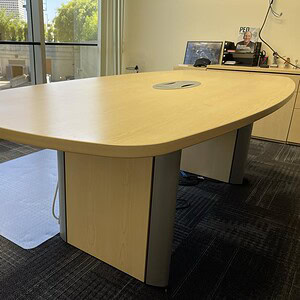 Conference table with maple finish for professional office settings.