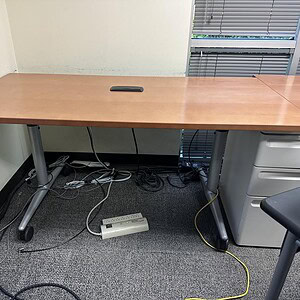 Training table with a wooden surface and metal legs, ideal for office or training room setups.