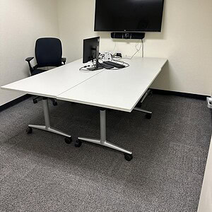 Office workspace featuring Cube World USA mobile table with monitor and chair.