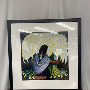 Woman holding a bouquet of flowers in a framed artwork.