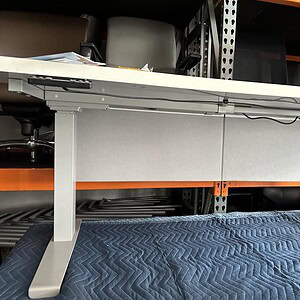 Modesty panel in grey fabric with white trim, ideal for office desks, providing privacy and a profes.
