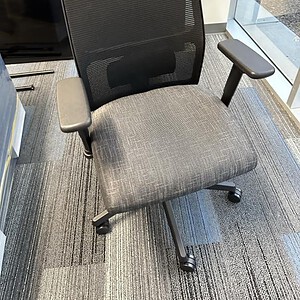 Ergonomic office chair with black mesh back and charcoal seat for comfort.