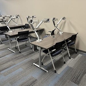 Powered training table with adjustable height and integrated monitors for effective training session.