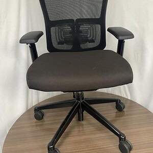 Ergonomic Haworth Zody office chair with adjustable armrests and mesh back.