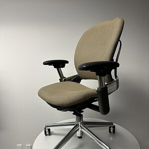 Office chair with beige fabric, adjustable armrests, and chrome base for ergonomic comfort.