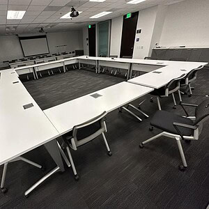 Nucraft powered white mobile training tables arranged in a conference room.
