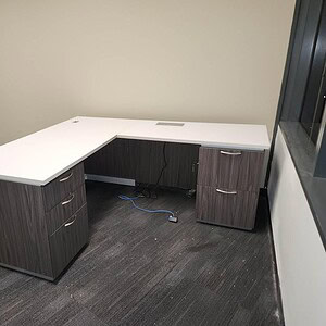 Elegant Tuxedo two-tone slate and white glass L-shaped desk for modern office spaces.