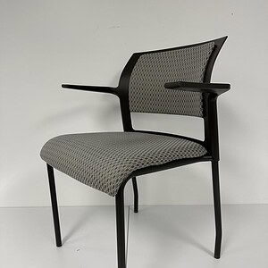 Modern Steelcase Cobi guest chair with neutral fabric and sleek black frame.