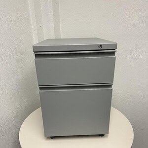 Light grey Herman Miller mobile pedestal for office storage.