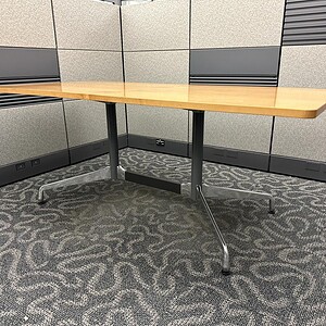 Herman Miller Eames style natural wood desk for modern office spaces.