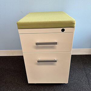 Mobile pedestal with green cushion for office or outdoor use. Compact storage solution featuring two.