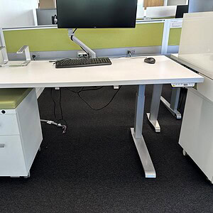 Adjustable height desk for ergonomic workspace comfort, ideal for offices and workstations.