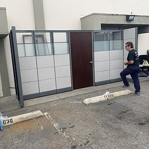 Office room divider with door, 86 inches tall, for versatile space division solutions.