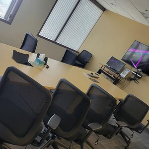 Modern Maple 16x4 rectangular conference table in a professional office setting.